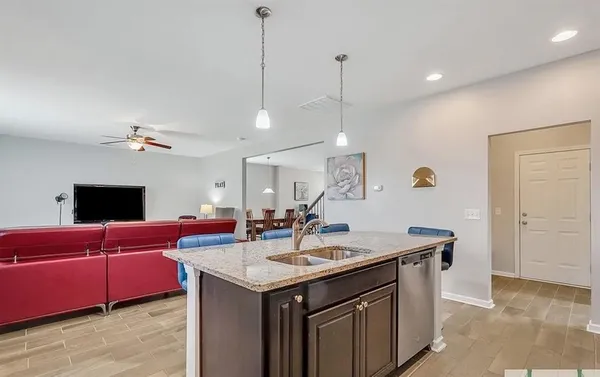 a view of living room with granite countertop furniture and a chandelier