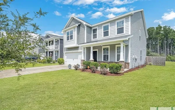 a front view of a house with a yard