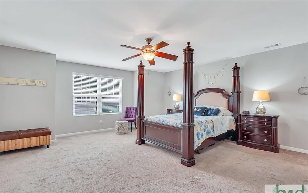 365 Southwilde Way Pooler, GA 31322 - Photo 32 of 50 a bedroom with bed and a chandelier