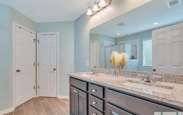 a bathroom with a glass shower door