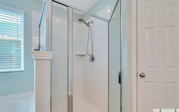 a bathroom with a sink a toilet a mirror a bathtub and shower