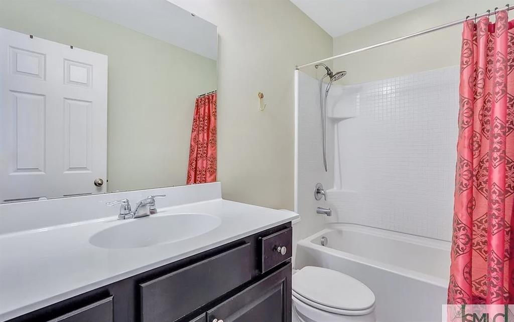 365 Southwilde Way Pooler, GA 31322 - Photo 36 of 50 a bathroom with a sink a toilet a mirror a bathtub and shower