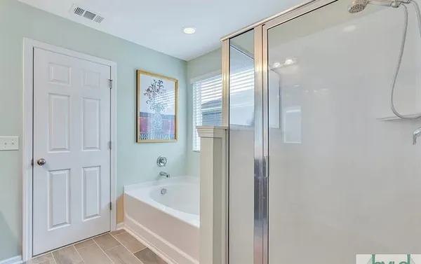 a bedroom with a bed and a ceiling fan