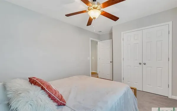 a bedroom with a bed and a chandelier