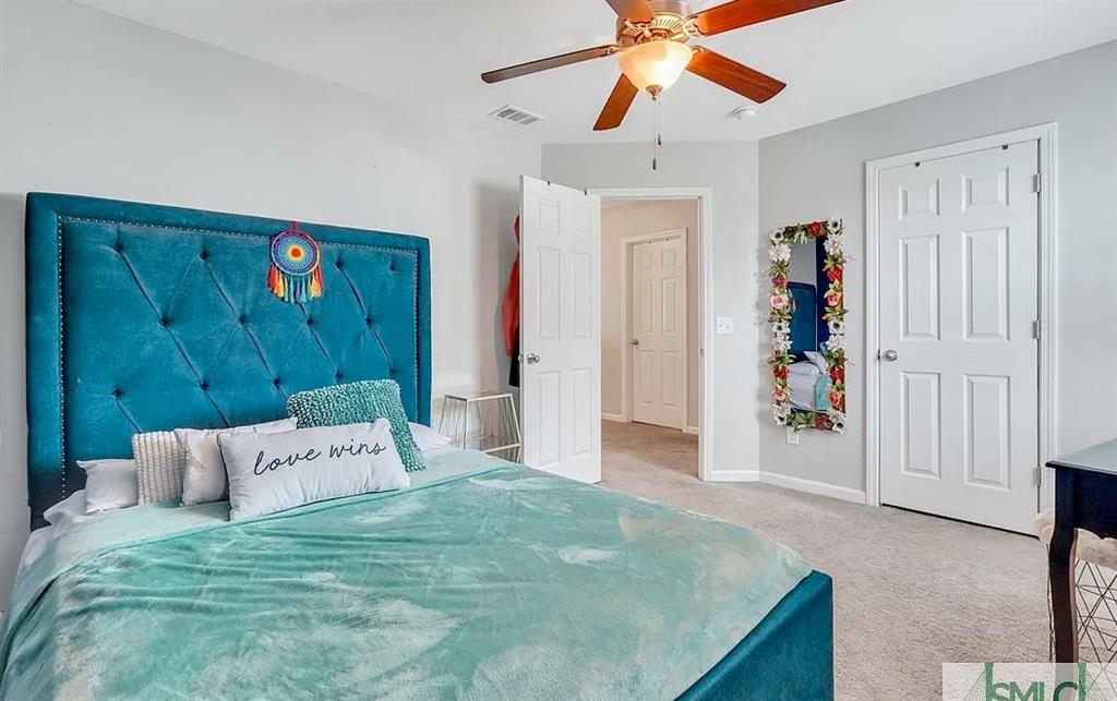 365 Southwilde Way Pooler, GA 31322 - Photo 41 of 50 a bedroom with a bed and a chandelier