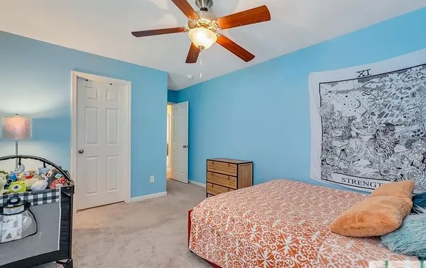 a bedroom with a bed and a chandelier