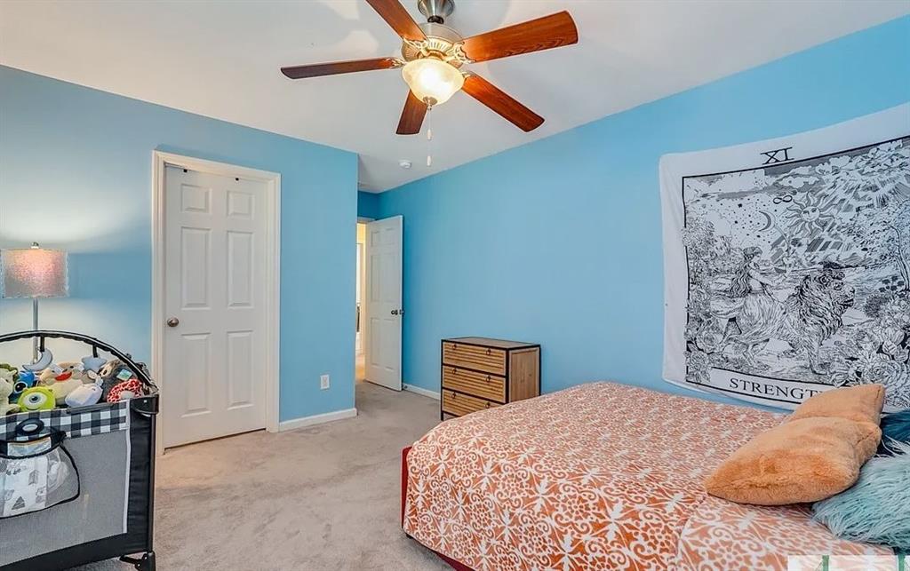 365 Southwilde Way Pooler, GA 31322 - Photo 43 of 50 a bedroom with a bed and a chandelier