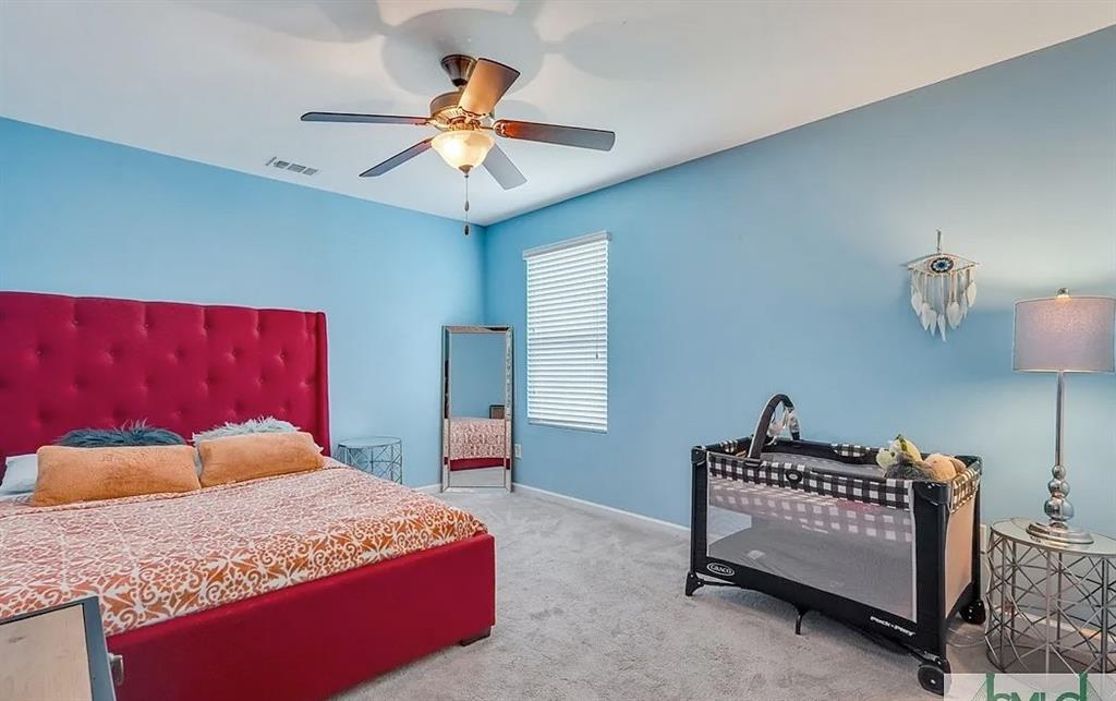 365 Southwilde Way Pooler, GA 31322 - Photo 44 of 50 a bedroom with a bed and a chandelier