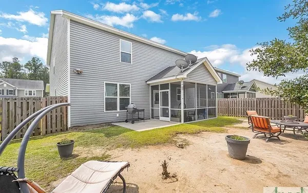a view of a house with pool and chairs