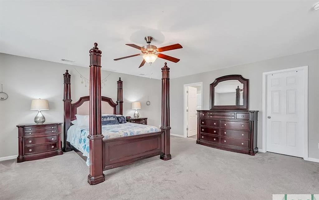 365 Southwilde Way Pooler, GA 31322 - Photo 6 of 50 a bedroom with a bed and a chandelier