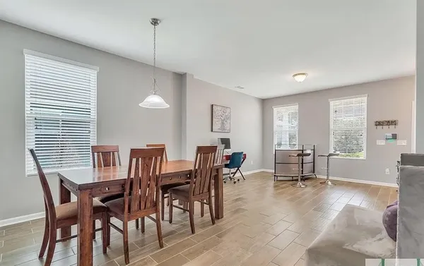 a view of a dining room with furniture and window
