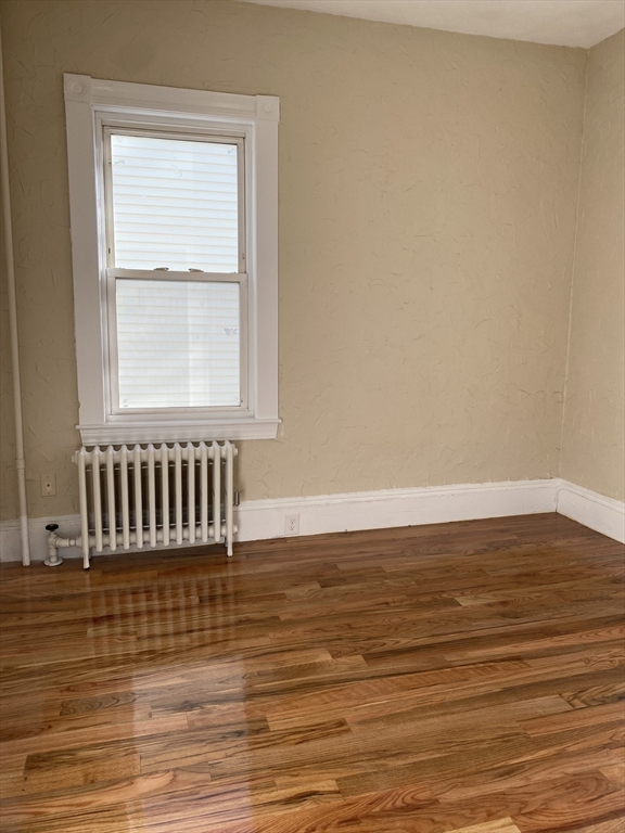 34 Porter Street, Unit 2 Malden, MA 02148 - Photo 12 of 12 a view of empty room with wooden floor and fan