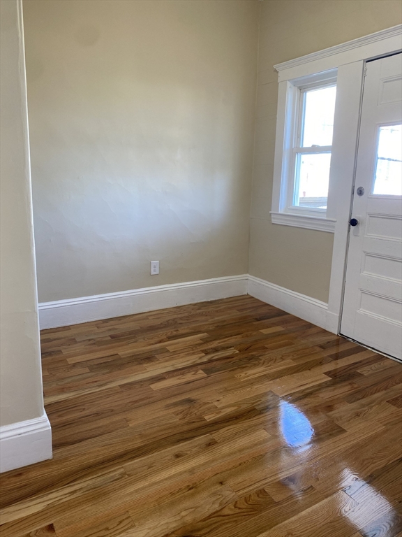 34 Porter Street, Unit 2 Malden, MA 02148 - Photo 2 of 12 a view of empty room with wooden floor and window
