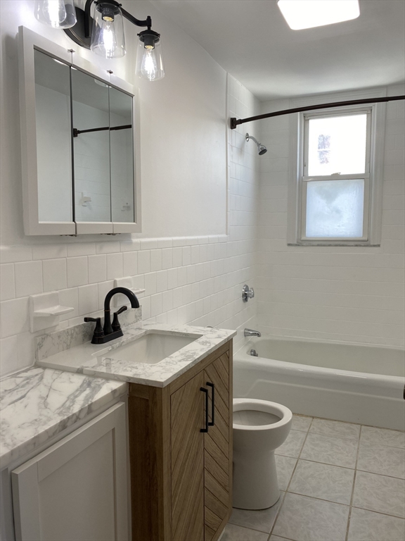 34 Porter Street, Unit 2 Malden, MA 02148 - Photo 6 of 12 a bathroom with a granite countertop sink toilet and shower