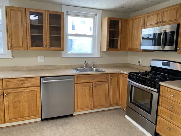a kitchen with stainless steel appliances granite countertop a stove and a sink