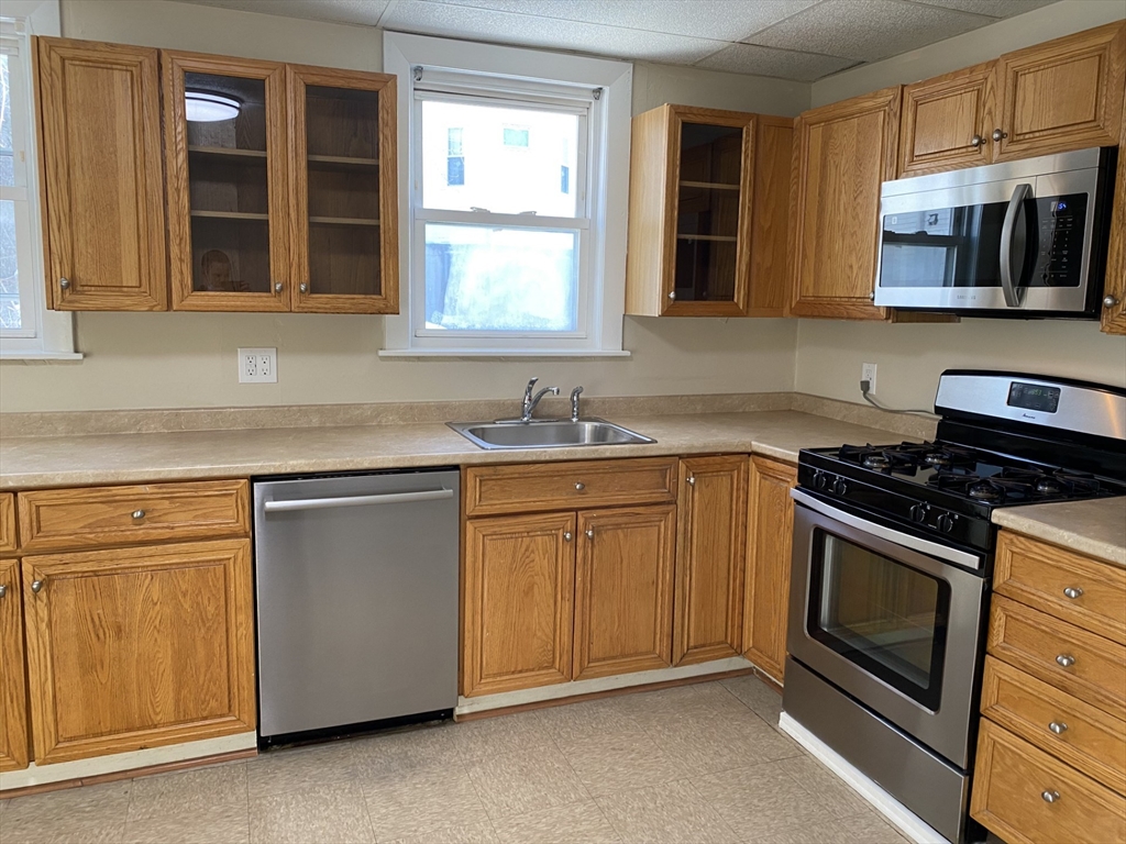 34 Porter Street, Unit 2 Malden, MA 02148 - Photo 9 of 12 a kitchen with stainless steel appliances granite countertop a stove and a sink
