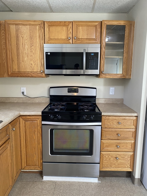 34 Porter Street, Unit 2 Malden, MA 02148 - Photo 10 of 12 a kitchen with stainless steel appliances granite countertop a stove microwave and sink