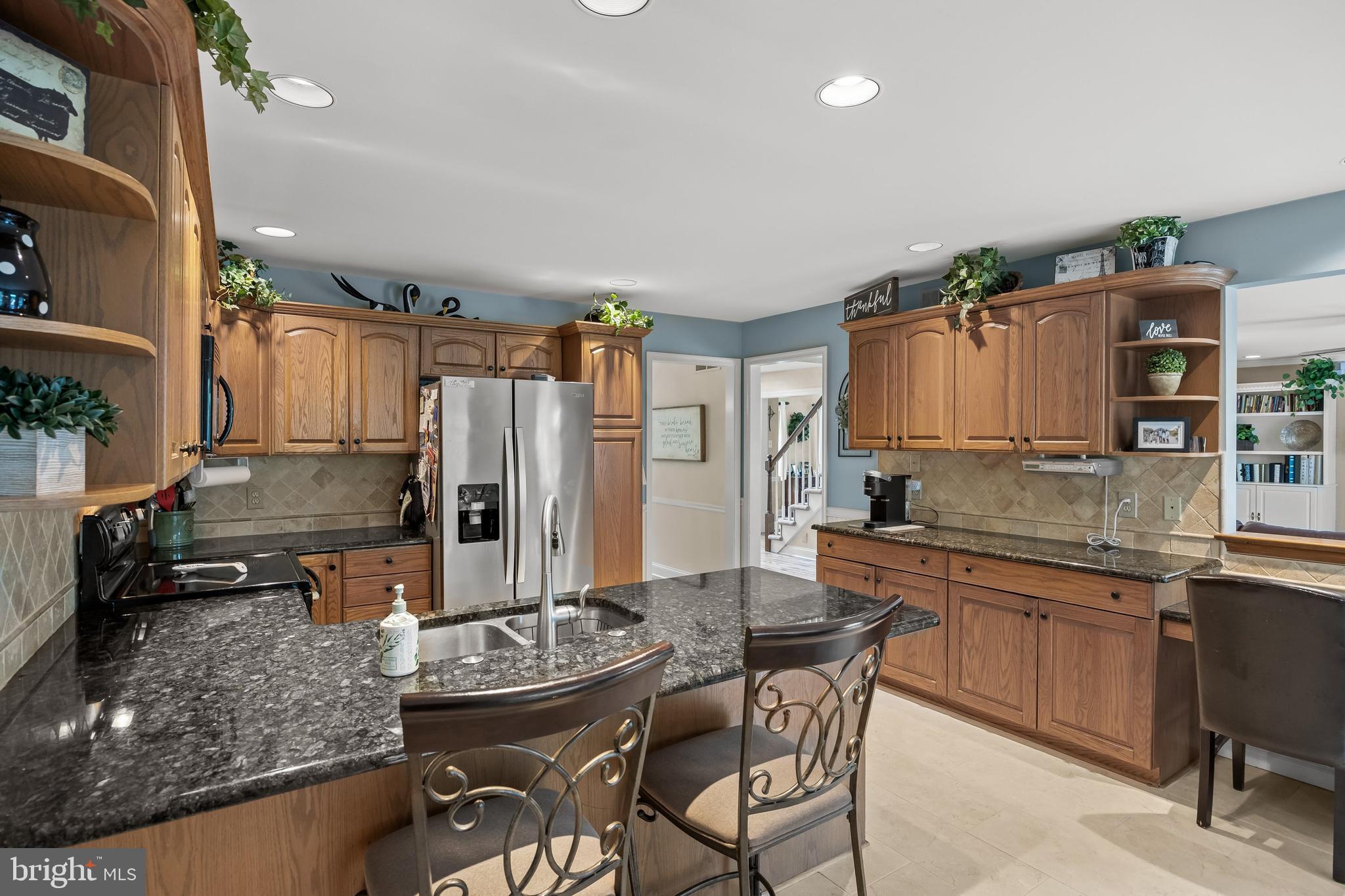 4 False Heather Way Medford, NJ 08055 - Photo 11 of 48 a kitchen with stainless steel appliances kitchen island granite countertop a sink and cabinets