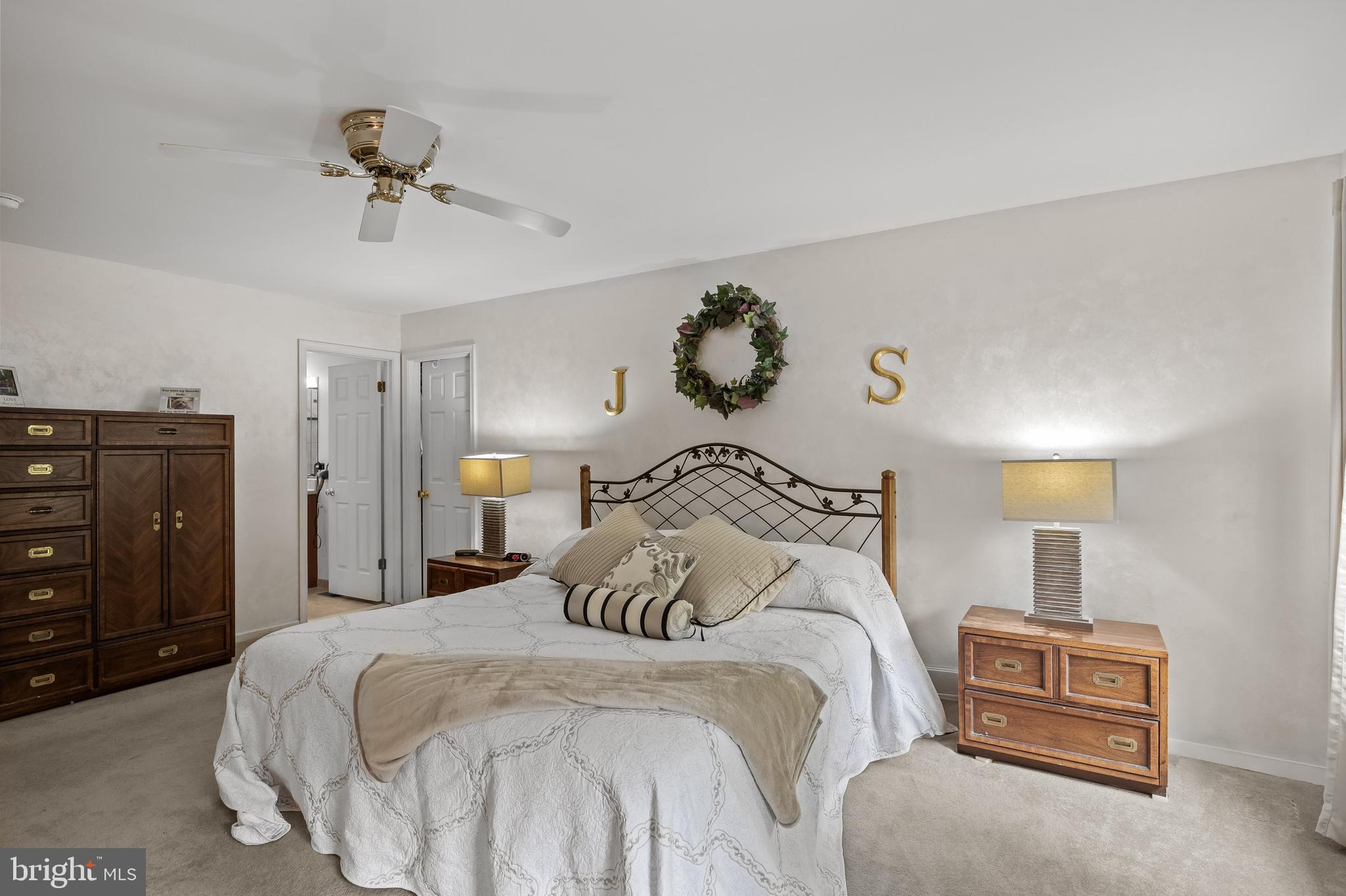 4 False Heather Way Medford, NJ 08055 - Photo 23 of 48 a bedroom with a bed and a chandelier