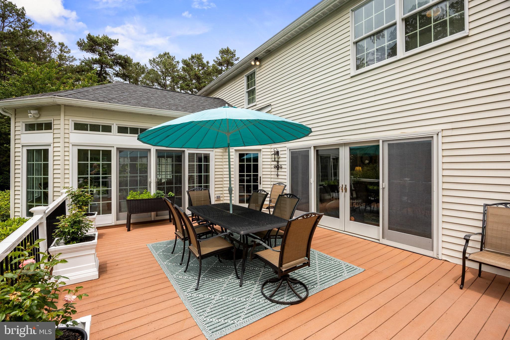 4 False Heather Way Medford, NJ 08055 - Photo 34 of 48 a view of a house with wooden deck and furniture