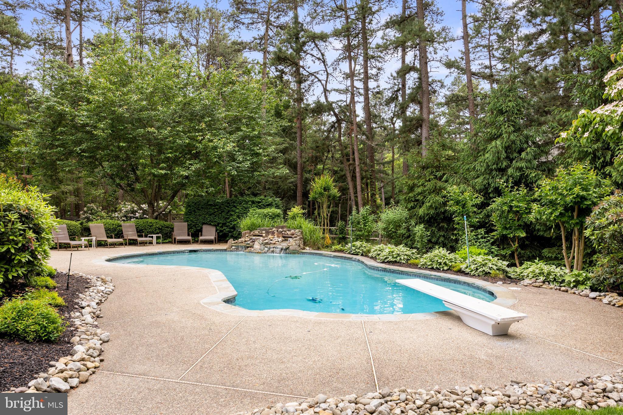 4 False Heather Way Medford, NJ 08055 - Photo 38 of 48 a view of swimming pool with sitting area and trees around