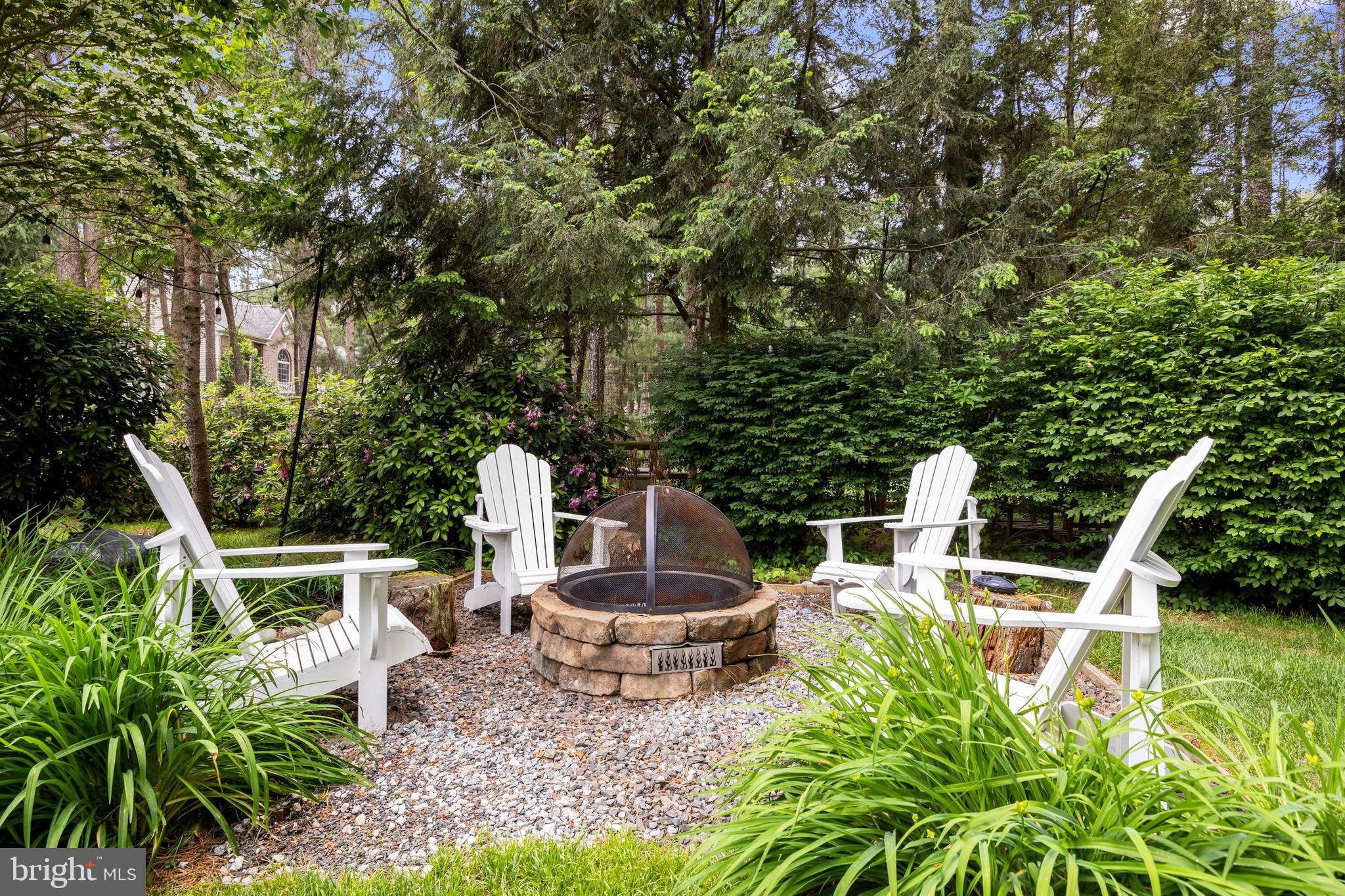 4 False Heather Way Medford, NJ 08055 - Photo 41 of 48 a view of a chair and tables in the backyard
