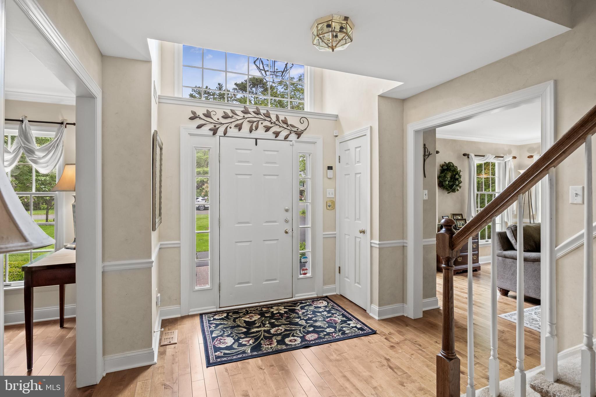 4 False Heather Way Medford, NJ 08055 - Photo 5 of 48 a view of a hallway with wooden floor and staircase
