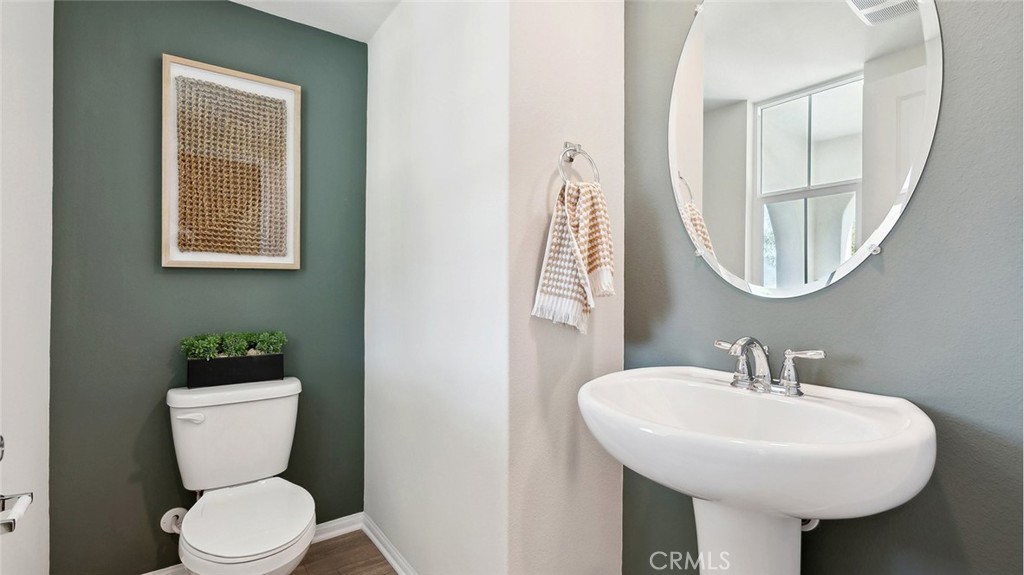 11392 Forge Road Corona, CA 92883 - Photo 11 of 24 a bathroom with a toilet sink and mirror