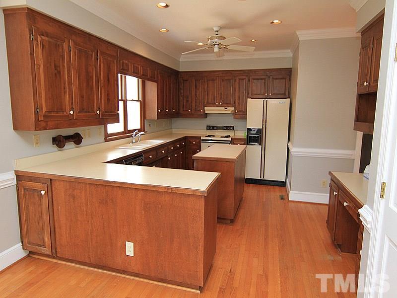 4013 Swarthmore Road Durham, NC 27707 - Photo 7 of 17 Large kitchen with center island. Wooden cabinets that could easily be painted for an updated look.