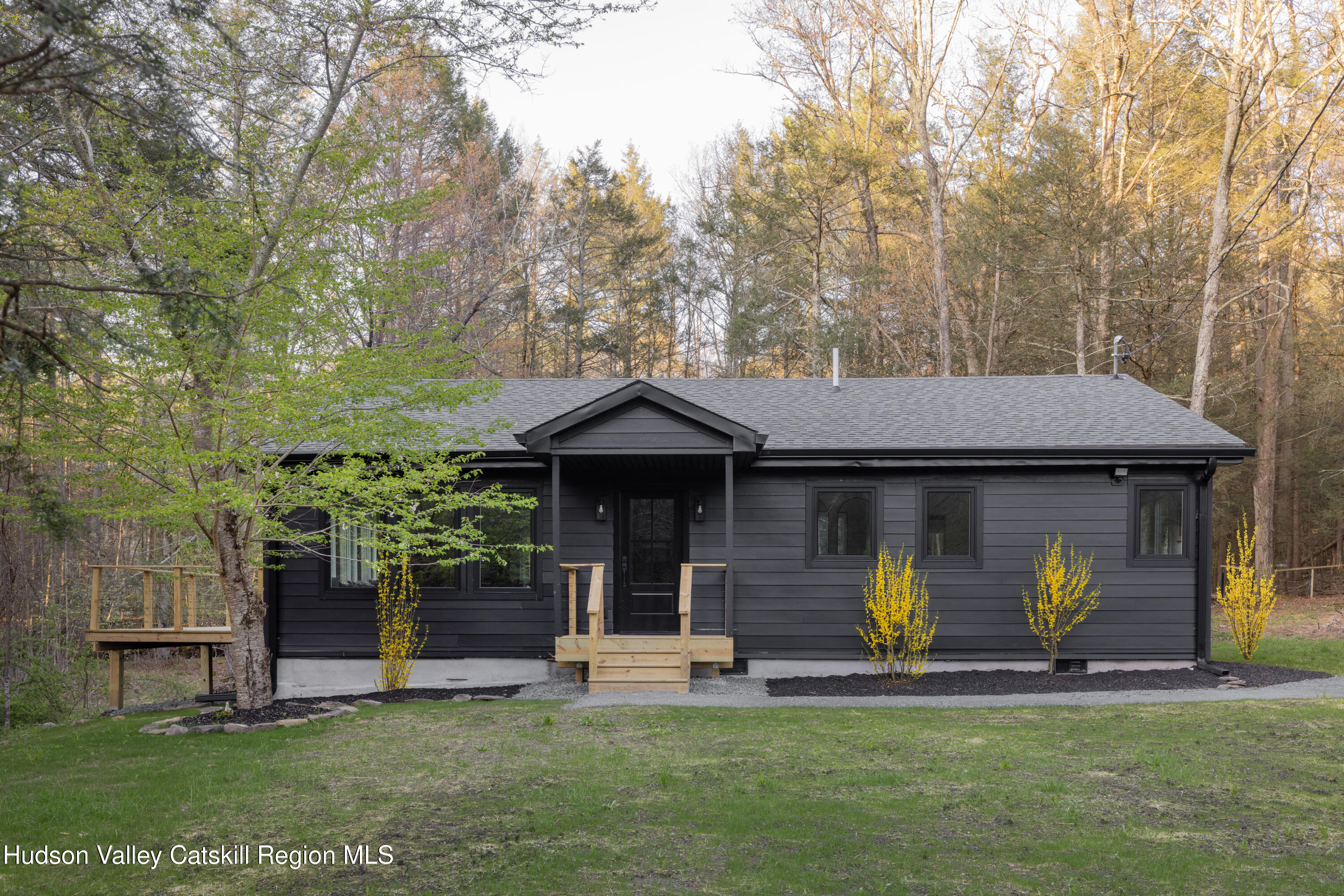 92 Upper Cherrytown Road Kerhonkson, NY 12446 - Photo 1 of 36 a front view of a house with a garden and trees