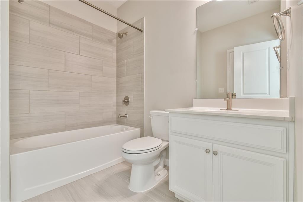 354 Provenance Drive Atlanta, GA 30328 - Photo 19 of 30 a bathroom with a sink a toilet and a bathtub