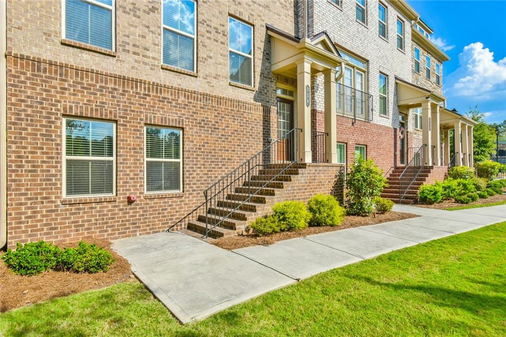 354 Provenance Drive Atlanta, GA 30328 - Photo 2 of 30 front view of a brick house with a yard