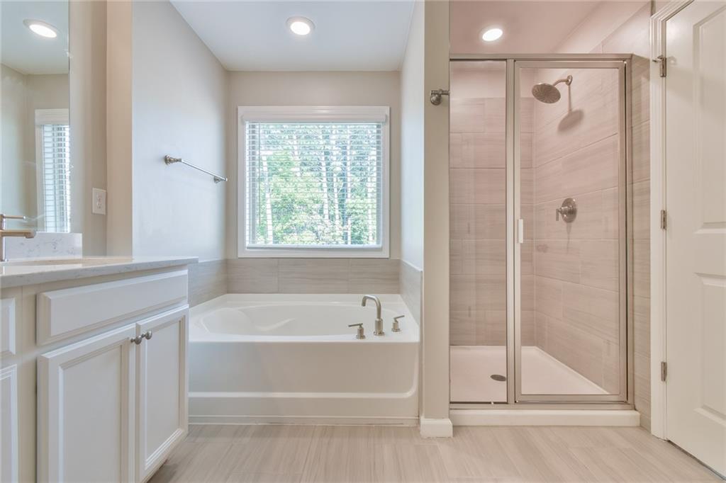 354 Provenance Drive Atlanta, GA 30328 - Photo 27 of 30 a bathroom with a bathtub and a shower