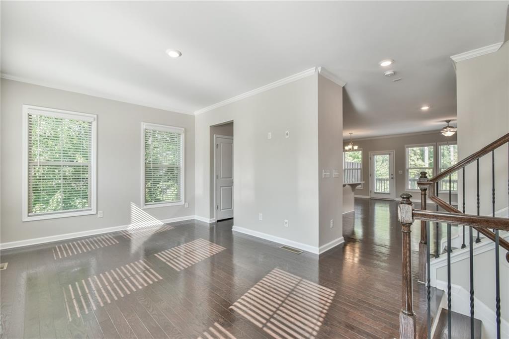 354 Provenance Drive Atlanta, GA 30328 - Photo 5 of 30 a view of an empty room with wooden floor and a window