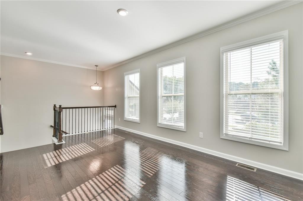 354 Provenance Drive Atlanta, GA 30328 - Photo 6 of 30 a view of an empty room with a window and wooden floor