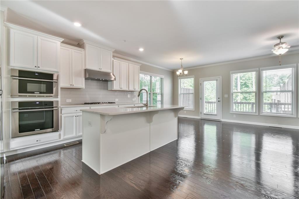 354 Provenance Drive Atlanta, GA 30328 - Photo 7 of 30 a kitchen with stainless steel appliances granite countertop a stove a sink and a microwave