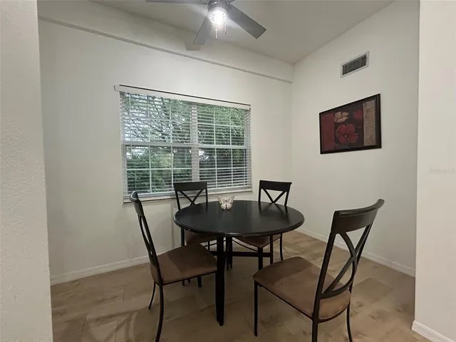 a dining room with furniture and window
