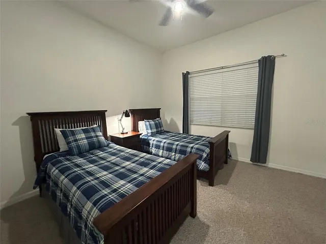 a bed sitting in a bedroom next to a window