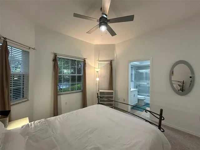 a bedroom with a bed a dresser and window