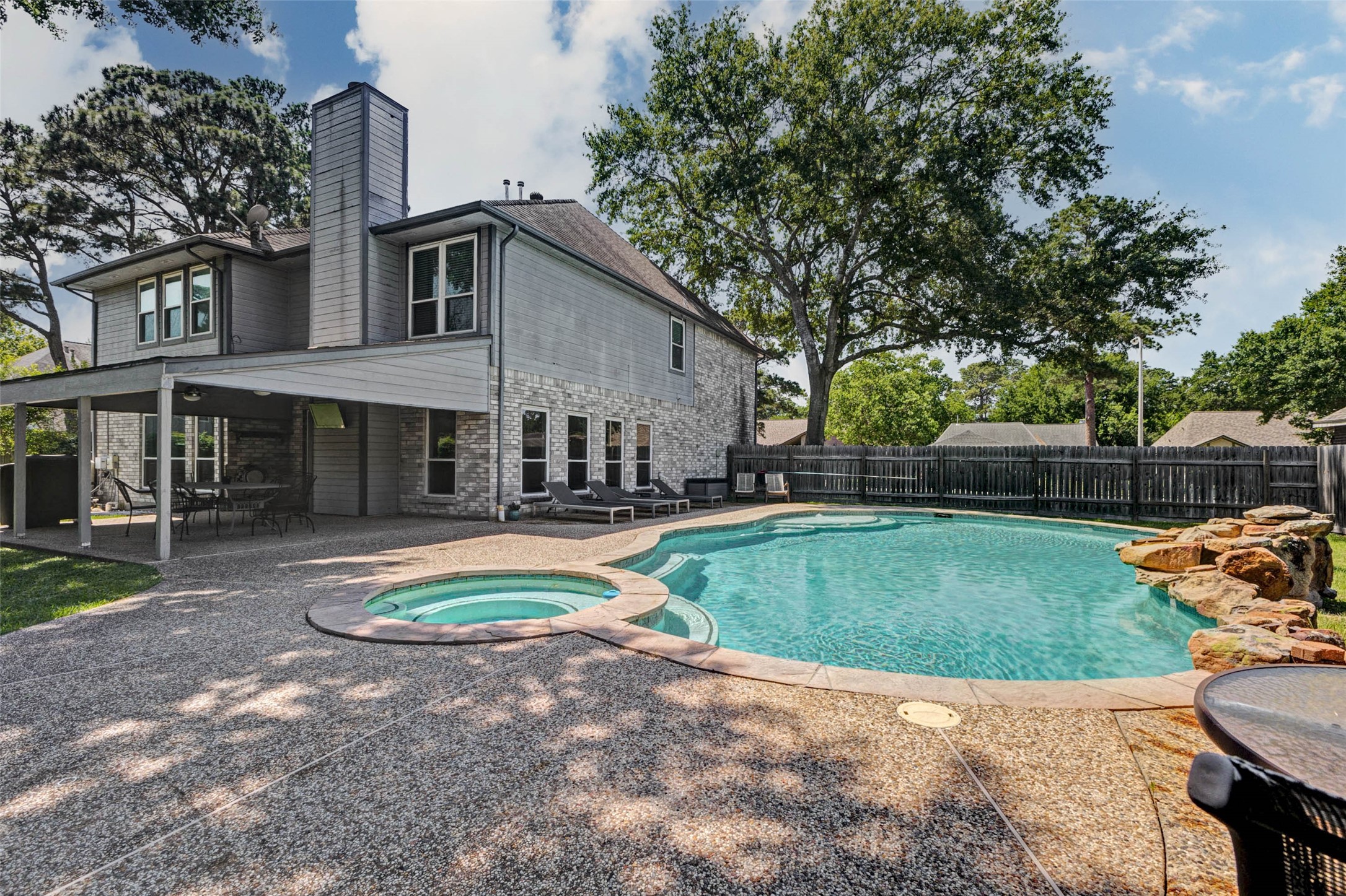 9215 Landry Boulevard Spring, TX 77379 - Photo 38 of 42 The backyard retreat also features a spacious circular spa that seamlessly connects to the pool. Multiple entry points into the pool add functionality.