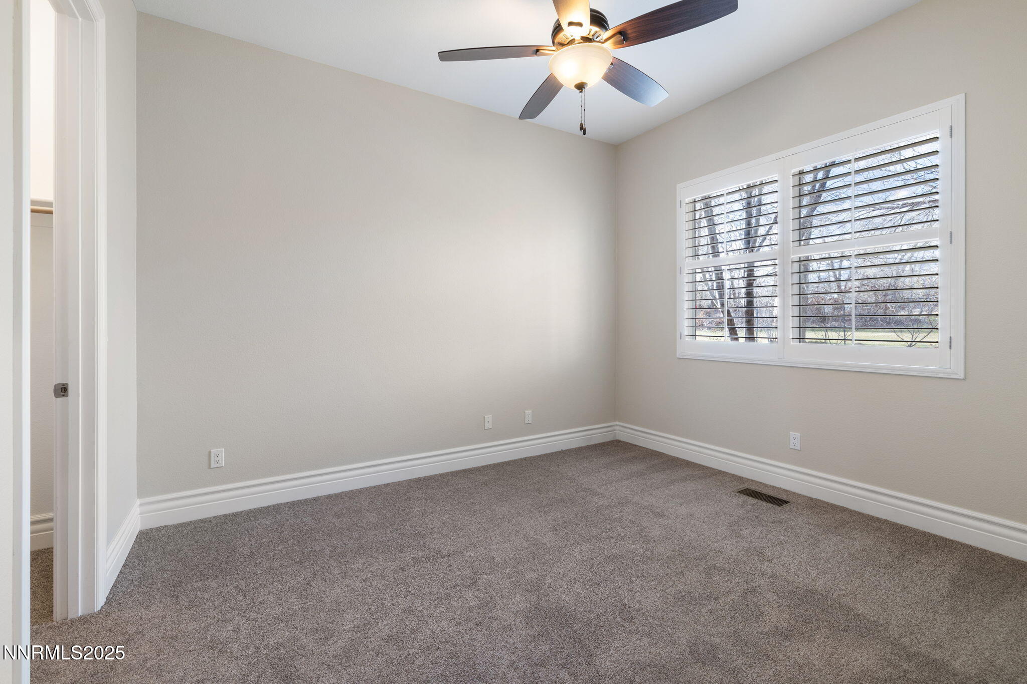 505 Sierra Manor Drive Reno, NV 89511 - Photo 19 of 36 an empty room with a window and a fan