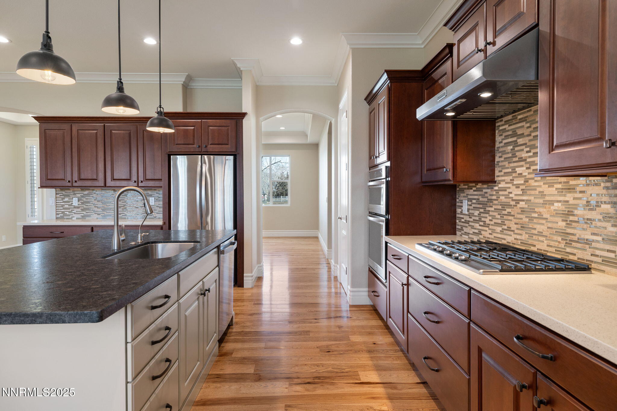 505 Sierra Manor Drive Reno, NV 89511 - Photo 9 of 36 a kitchen with stainless steel appliances granite countertop a sink a stove and a wooden floors