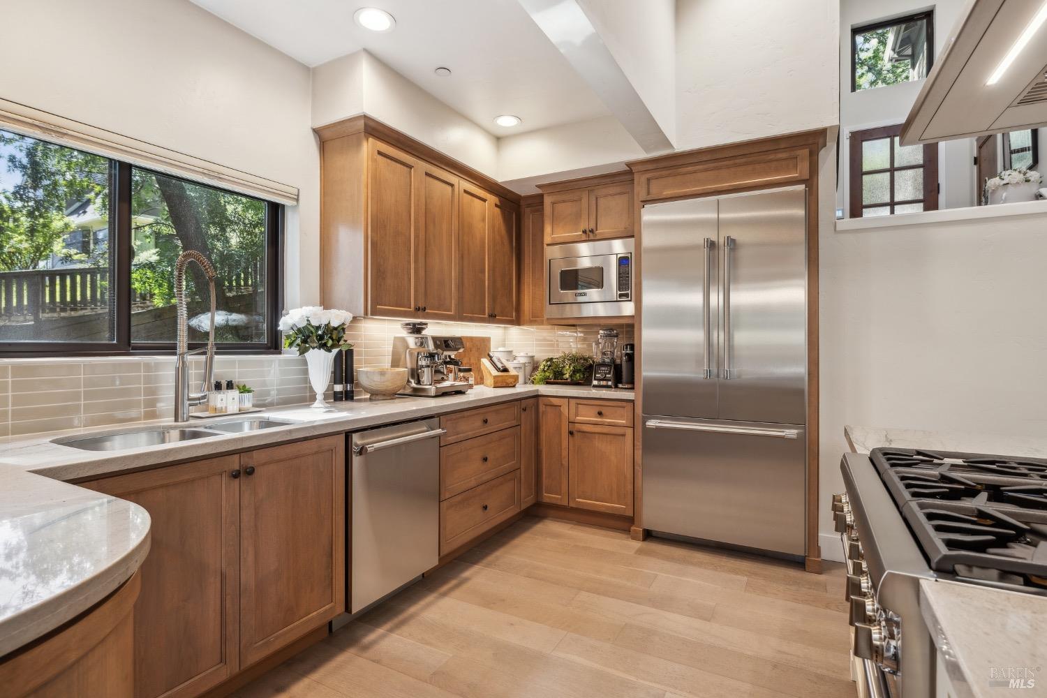 86 Fair Drive San Rafael, CA 94901 - Photo 13 of 65 a kitchen with stainless steel appliances granite countertop a sink stove and refrigerator