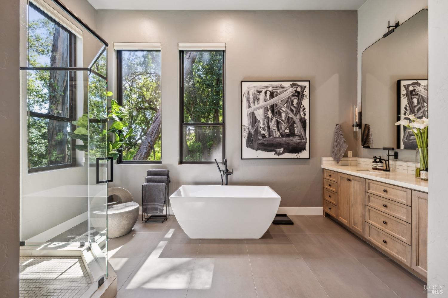 86 Fair Drive San Rafael, CA 94901 - Photo 32 of 65 a bathroom with a double vanity sink a large mirror a bathtub and next to a window