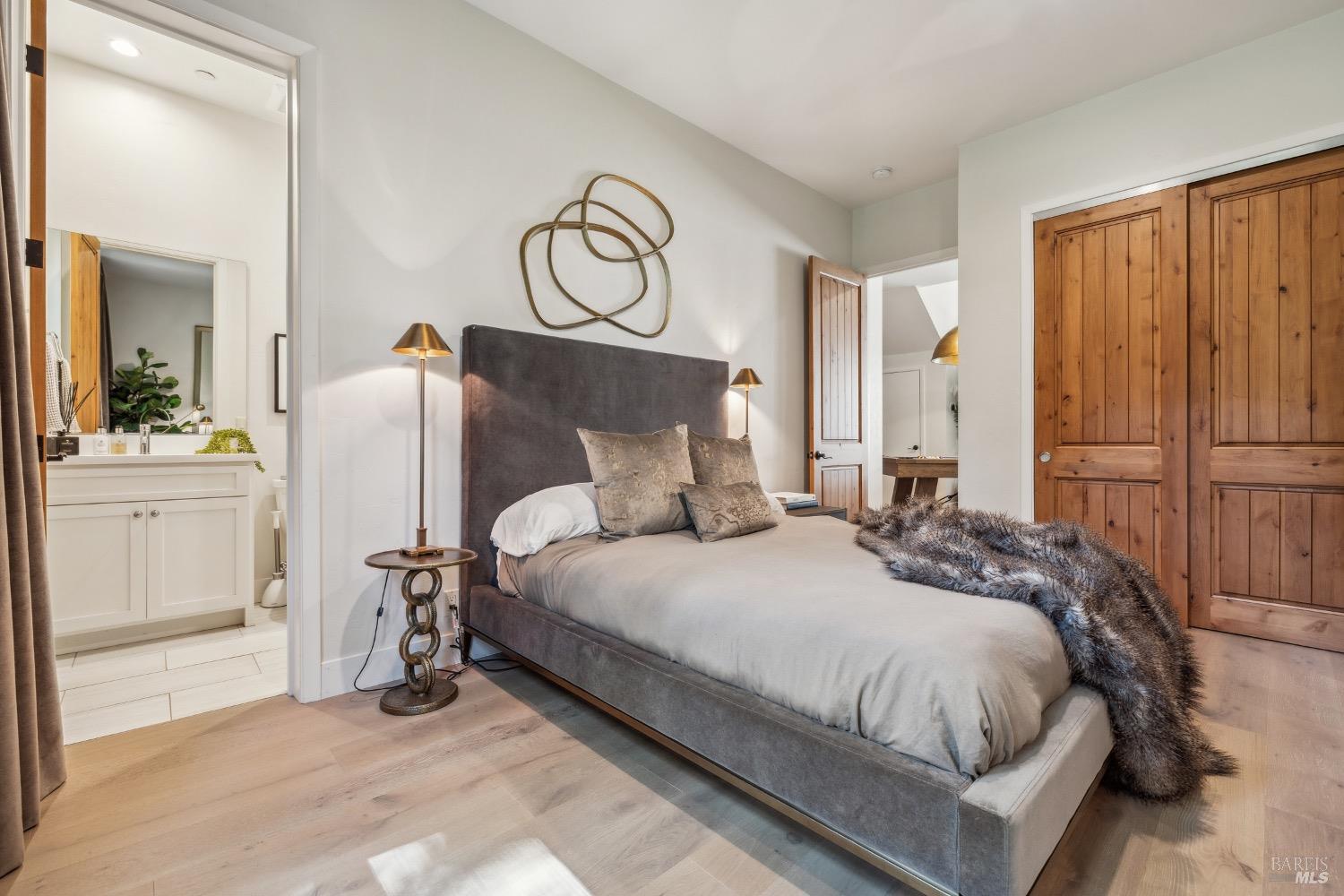 86 Fair Drive San Rafael, CA 94901 - Photo 39 of 65 a large bed sitting in a bedroom next to a cabinet and a mirror