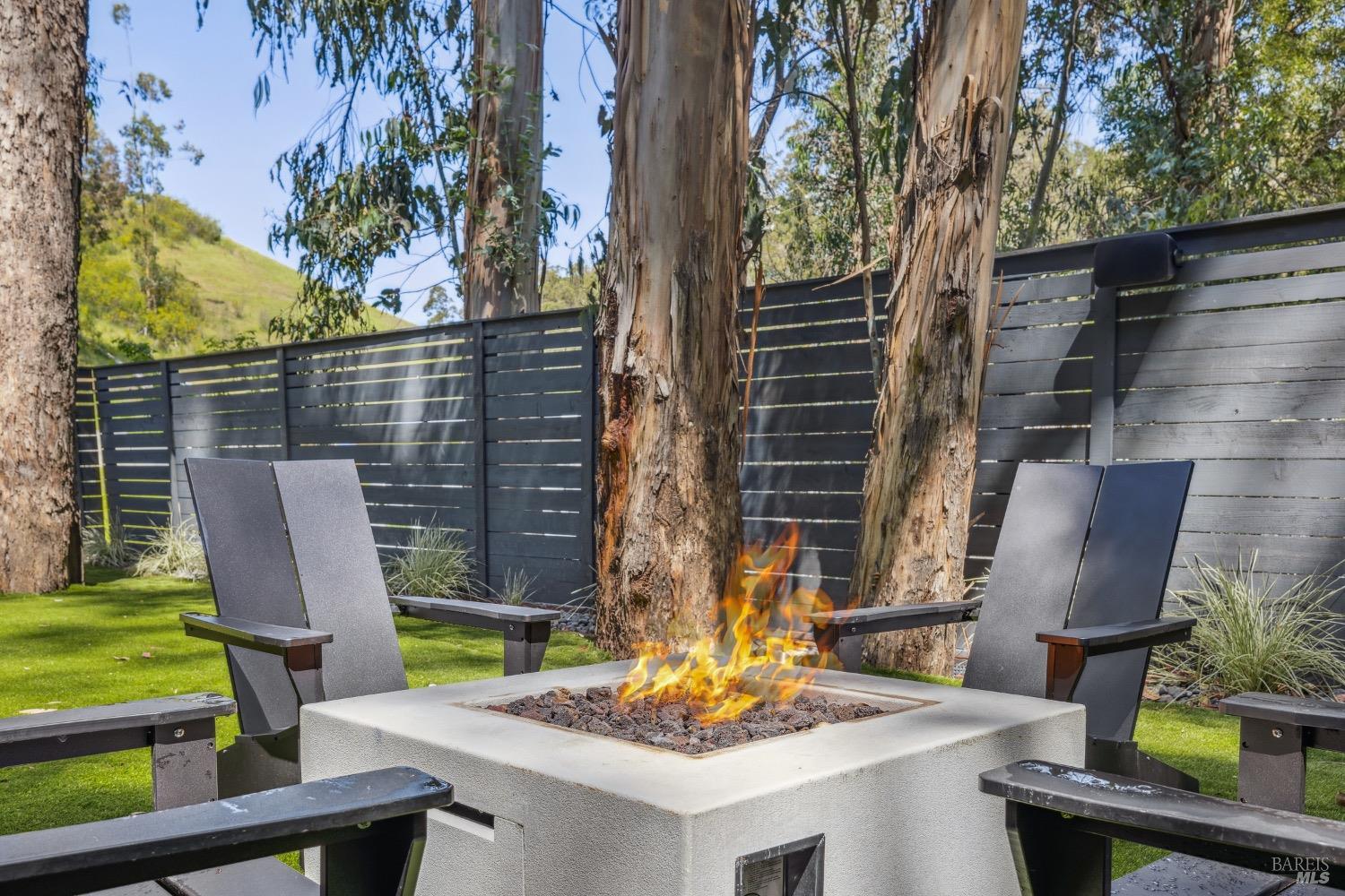 86 Fair Drive San Rafael, CA 94901 - Photo 57 of 65 a view of a patio with table and chairs with wooden fence and plants