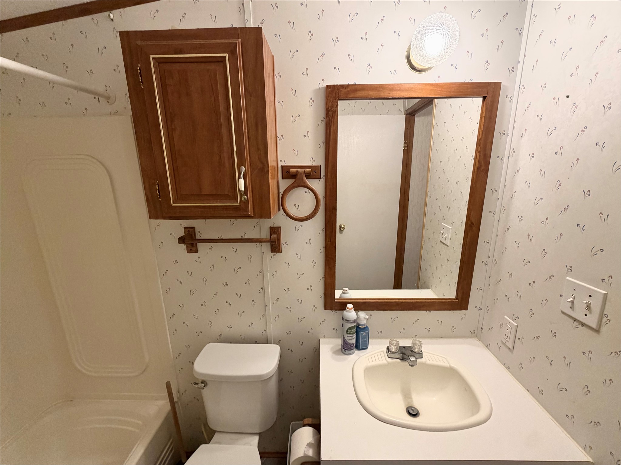 153 Prairie Lea Drive Angleton, TX 77515 - Photo 20 of 30 a bathroom with a toilet sink and mirror