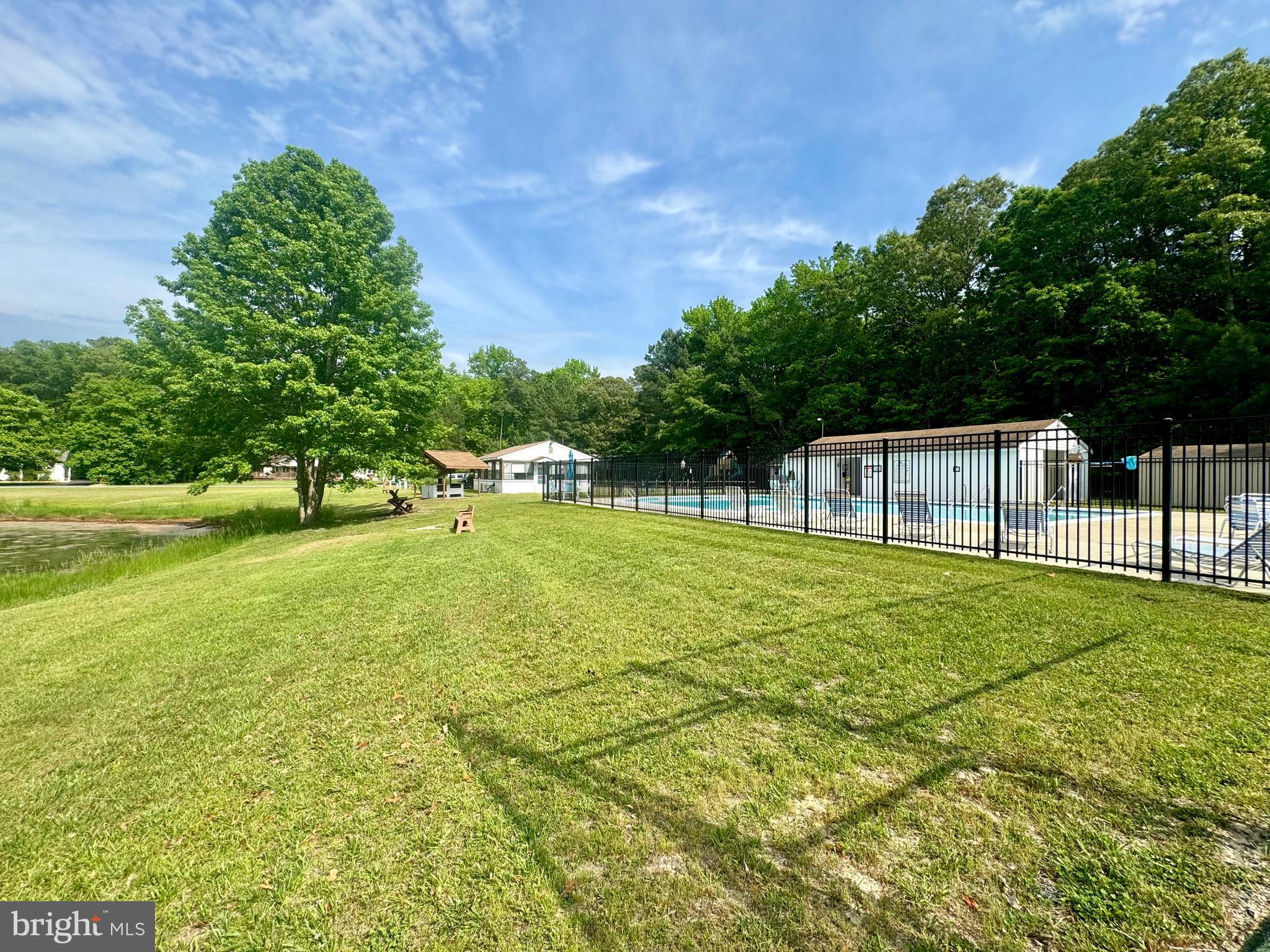 34404 Owls Nest Road Lewes, DE 19958 - Photo 58 of 63 Pool, tennis courts, basketball hoop, pond