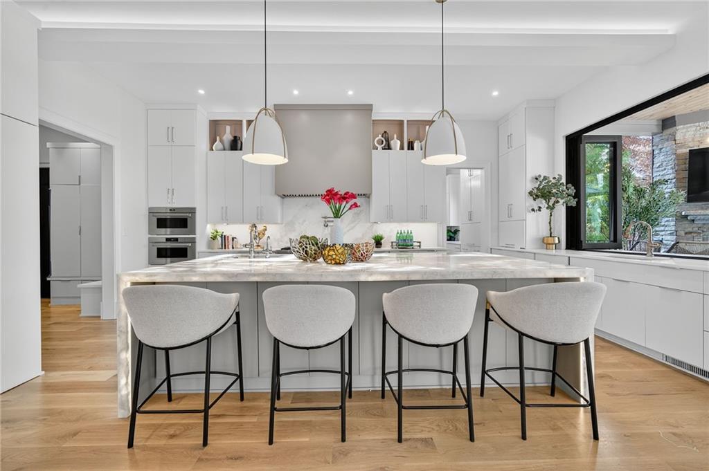 3565 Rivers Call Boulevard Atlanta, GA 30339 - Photo 11 of 78 a kitchen with stainless steel appliances granite countertop a dining table chairs and sink