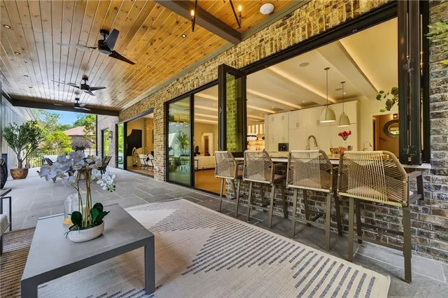 a kitchen with stainless steel appliances a stove and white cabinets